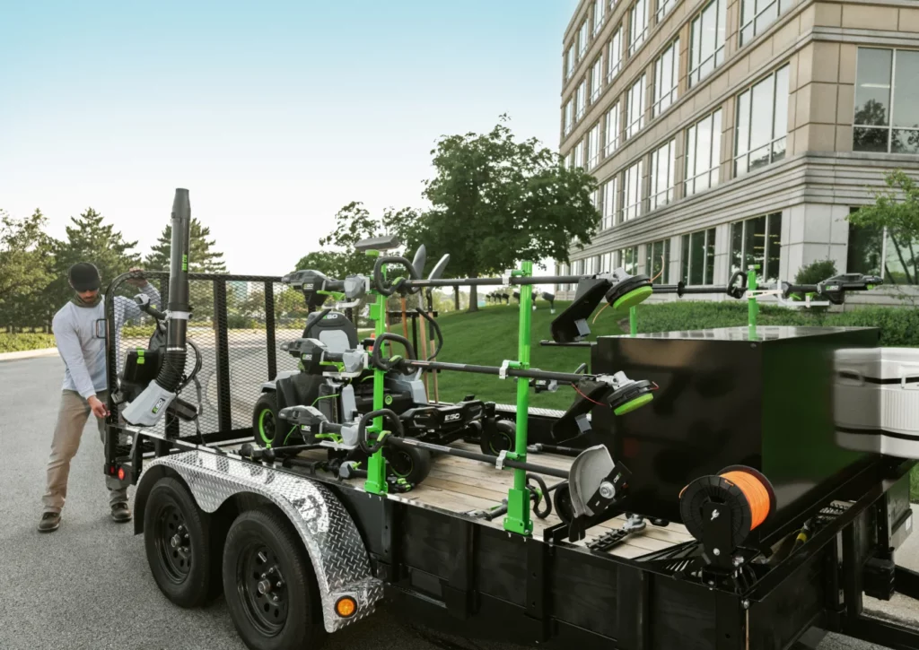 Guy loading a trailer full of EGO POWER+ lawn and garden products